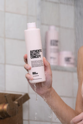 Authentic Beauty Concept bottle on bathroom shelf styled for everyday routine benefit