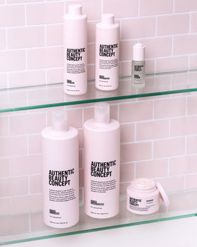 Authentic Beauty Concept bottle beside color chart illustrating color-preserving benefit