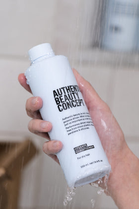Authentic Beauty Concept bottle on bathroom shelf suggesting daily use benefits
