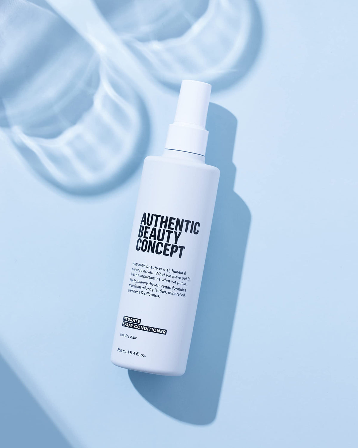 Authentic Beauty Concept bottle in hand showing portable travel-friendly size