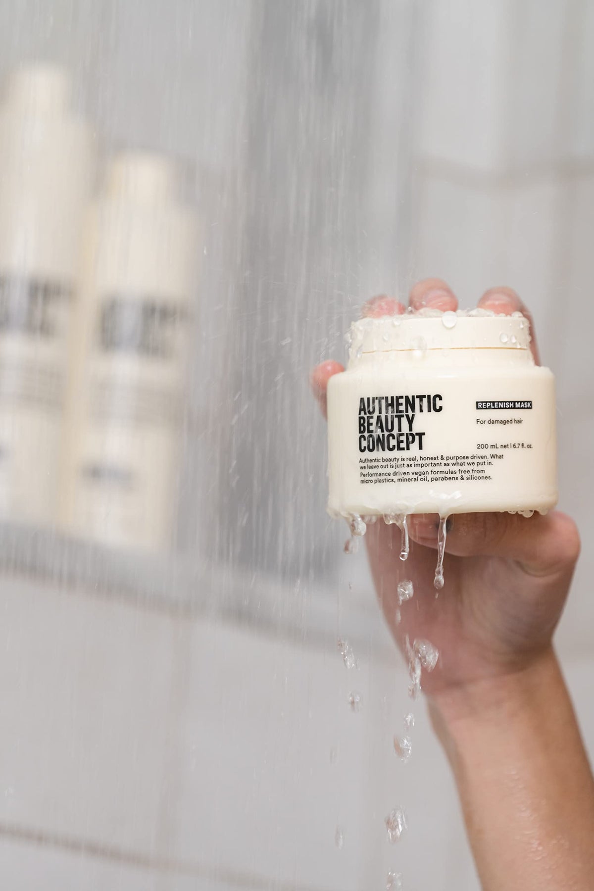 Authentic Beauty Concept ingredient bottle with active elements, highlights clean formulation