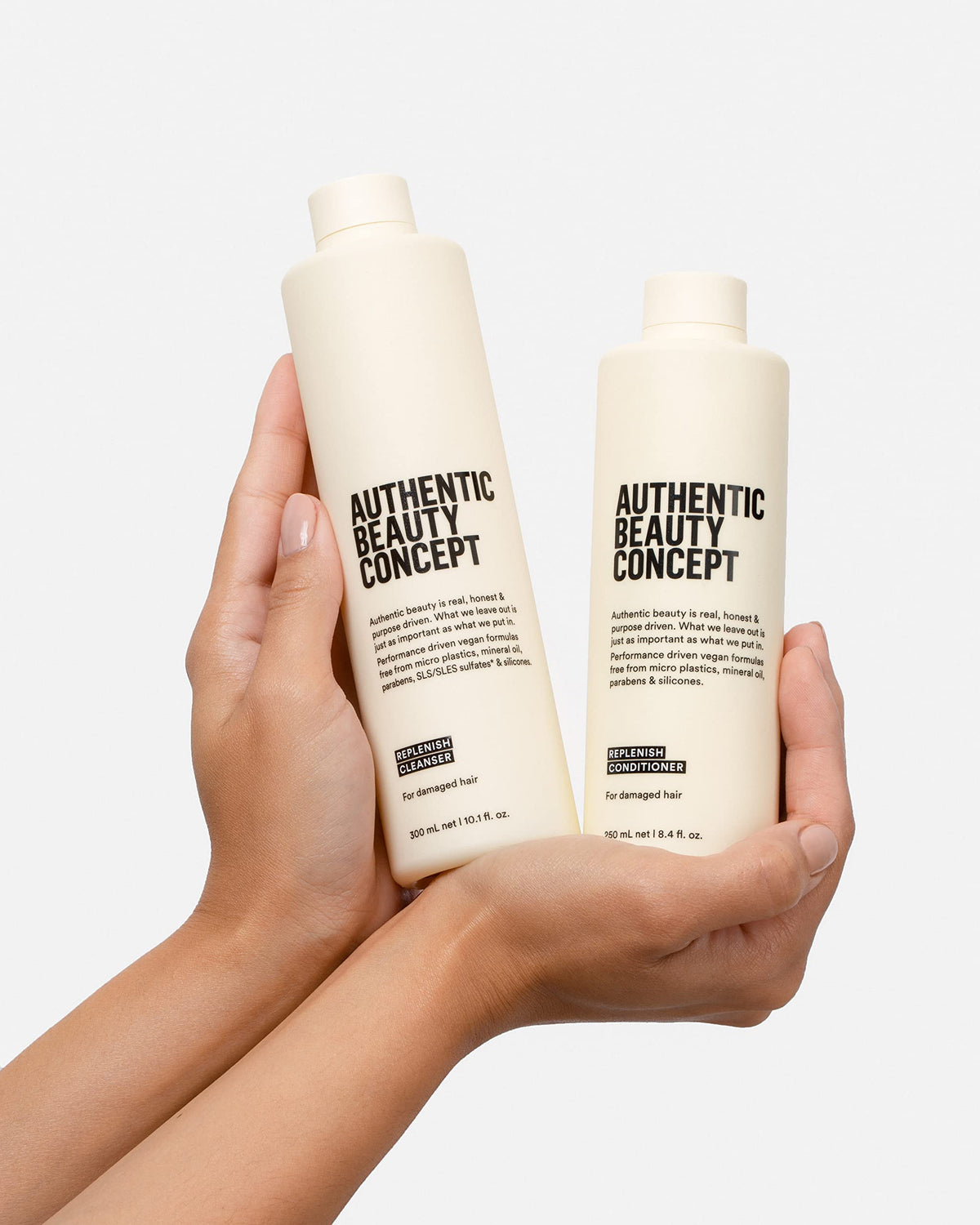 Authentic Beauty Concept next to a hand for size comparison and travel-friendly volume