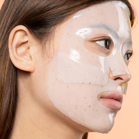 Hands applying Avatara hydrogel mask showing easy application and adherence