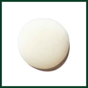 Aveda product label close-up showing ingredient claims and certification badges for trust
