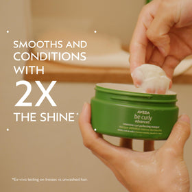 Aveda Be Curly open jar texture close-up demonstrating creamy slip
