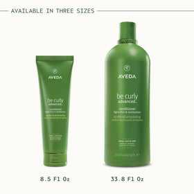 Aveda Be Curly bottle surrounded by citrus essences highlighting Pure-Fume scent