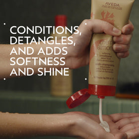 Close-up of conditioner texture poured from bottle showing creamy slip and nourishing feel