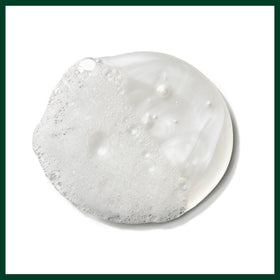 Aveda bottle in hand showing 33.8 fl oz scale and long-lasting supply