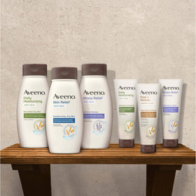 Aveeno bottle next to hand for size comparison and user-friendly design