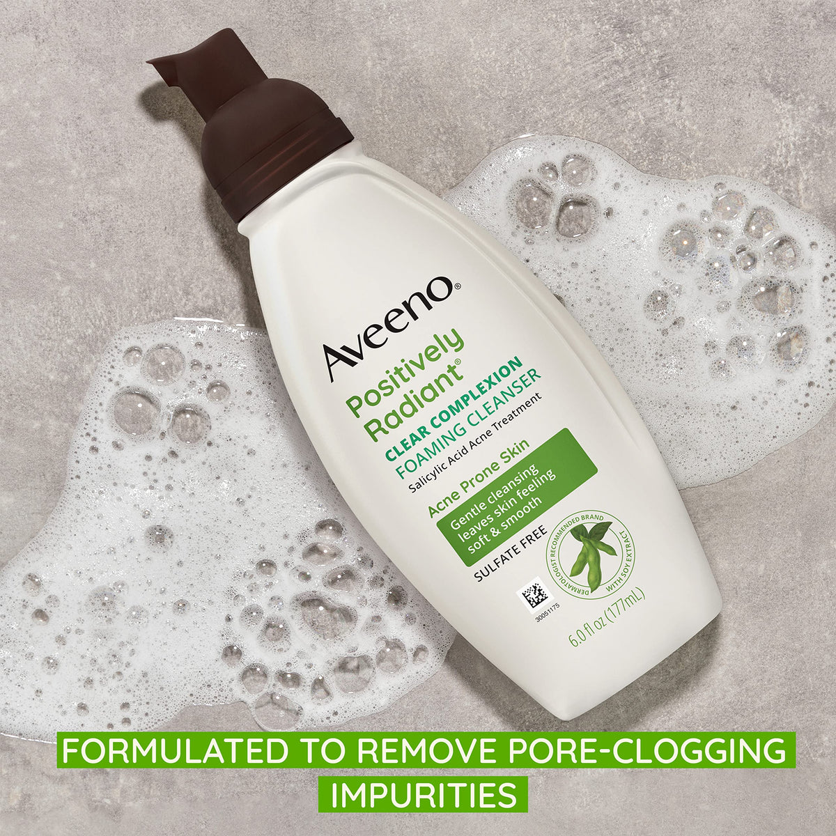 Aveeno bottle in hand for scale and one-handed everyday use