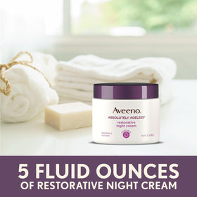 Aveeno night cream on bedside table suggesting nightly skincare routine