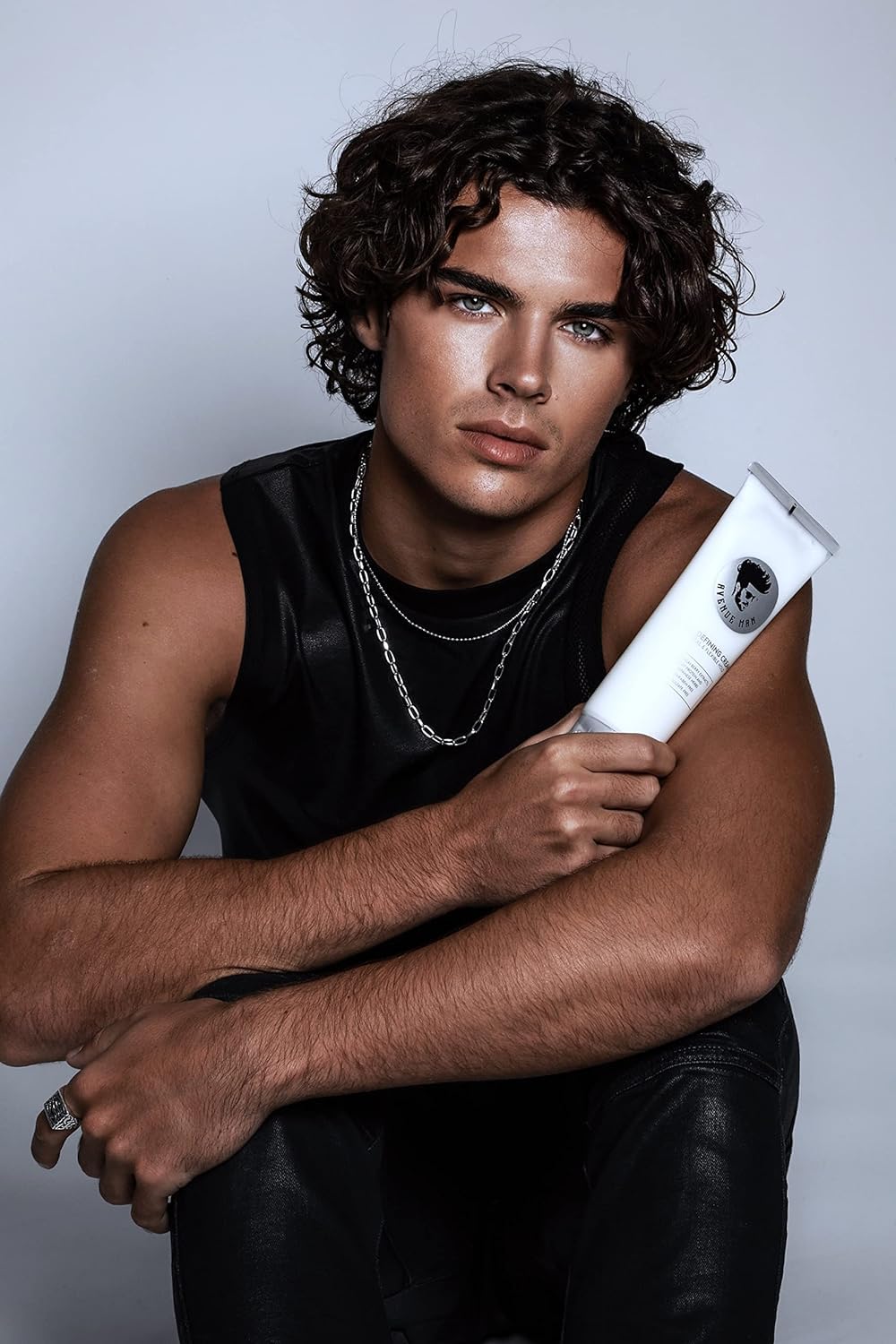 Avenue Man stylist applying cream during barber session for professional finish