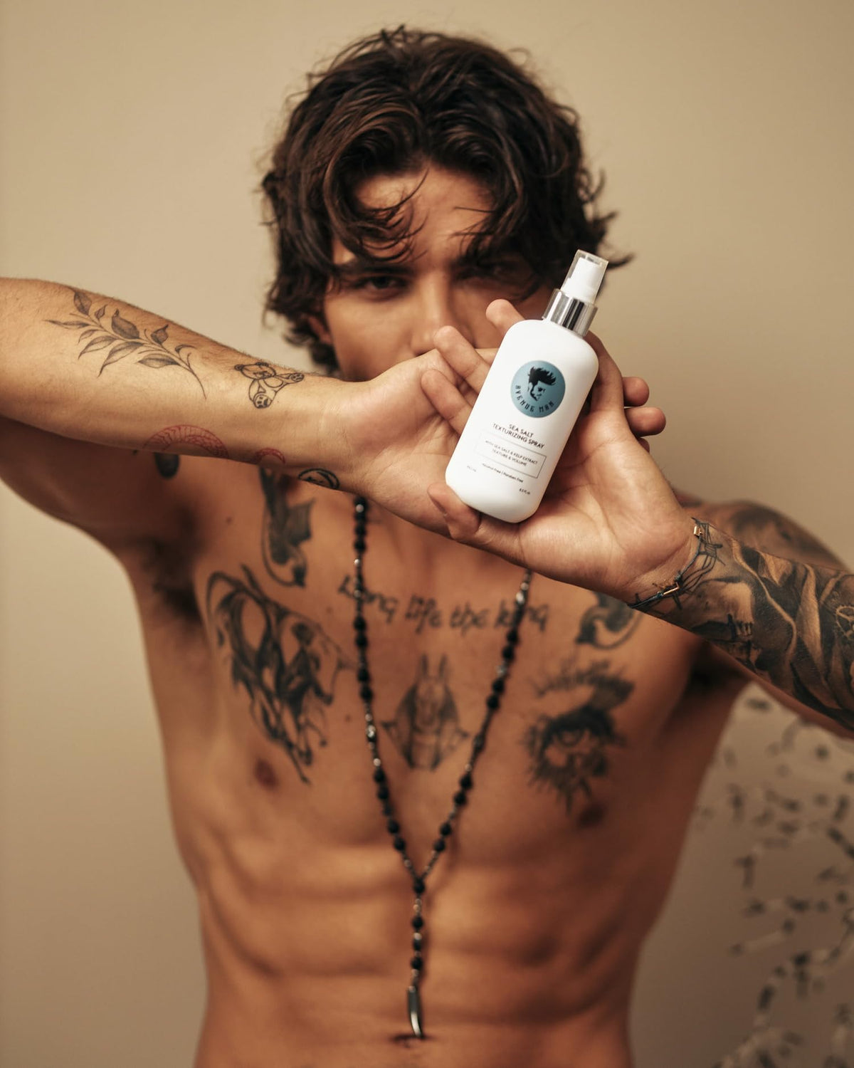 Avenue Man bottle held in hand to show 6.76 oz scale and travel-friendly size