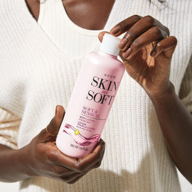 AVON application on forearm in a bathroom setting, demonstrates fast-absorbing daily hydration