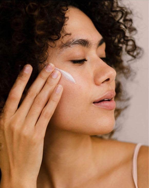 AVON cream in hand showing 1.7 fl oz scale and easy portability advantage