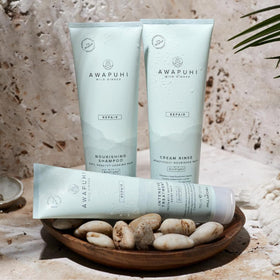 Bottle in hand size comparison of Awapuhi Wild Ginger showing travel-friendly volume