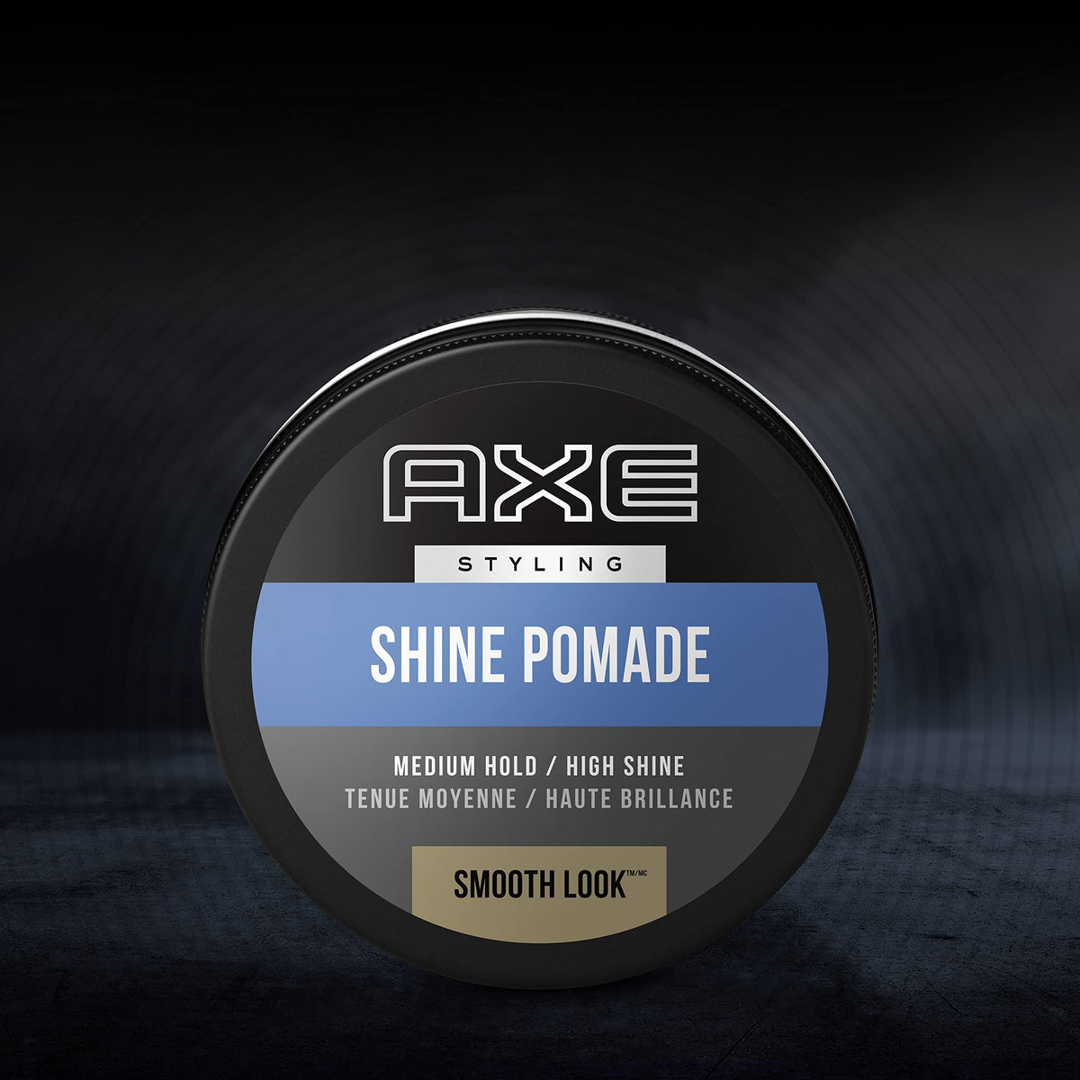 AXE pomade next to a coin for scale showing compact 2.64oz portability