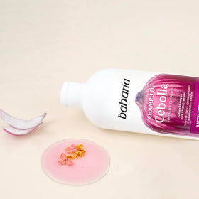 Size comparison of Babaria 20 oz bottle held to show scale and value