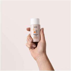 Babe 50 ml tube next to common object to show travel-friendly size