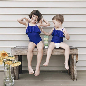 Babo Botanicals applied on child at beach showing family-safe use