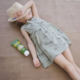 Babo Botanicals placed by towel showing post-sun recovery routine