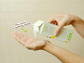 Babo Botanicals pouring product from bottle to show easy-dispense pump and controlled use