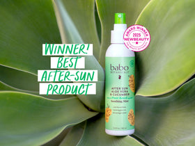 Babo Botanicals 8 oz bottle next to beach bag illustrating size