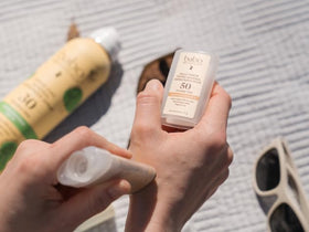 Babo Botanicals applying tint on cheek for even tone benefit