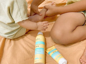 Babo Botanicals applied by parent on child outdoors showing family-friendly use