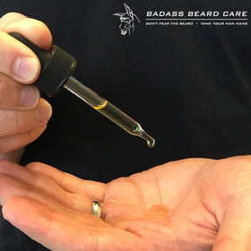 Badass Beard Care 1 oz bottle next to keys showing travel-ready grooming convenience