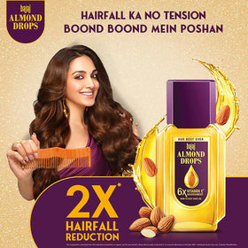 Bajaj Almond Drops oil pour close-up showing light texture for quick absorption benefit