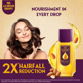 Bajaj Almond Drops pouring oil demonstrating lightweight texture for quick absorption