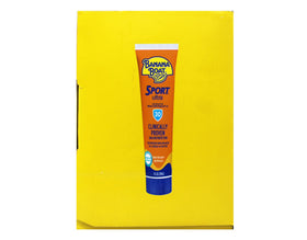 Applying Banana Boat sunscreen on arm during run showing sweat-resistant benefit