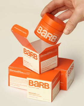 The Barb Shop soft clay pomade on a bathroom counter suggesting daily routine convenience