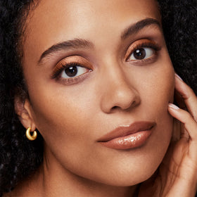 bareMinerals bronzer being applied with brush for natural, buildable warmth
