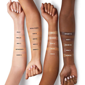 bareMinerals travel-size tube held in hand showing compact scale for on-the-go convenience benefit
