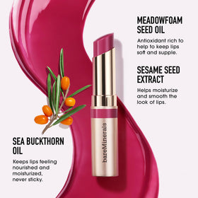 bareMinerals gloss-balm beside coin to show size and travel-friendly convenience