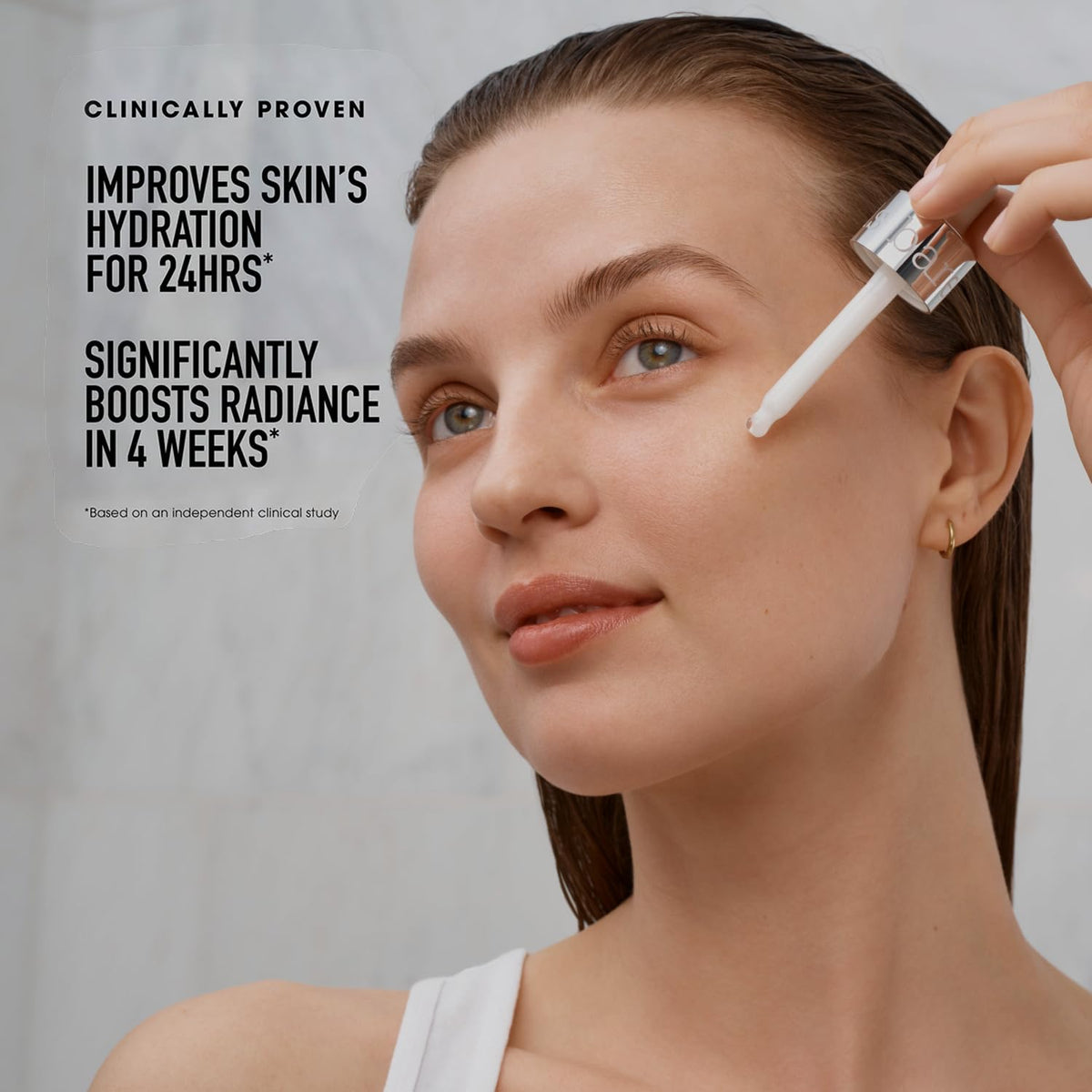bareMinerals bottle in hand for size comparison and travel-friendly benefit