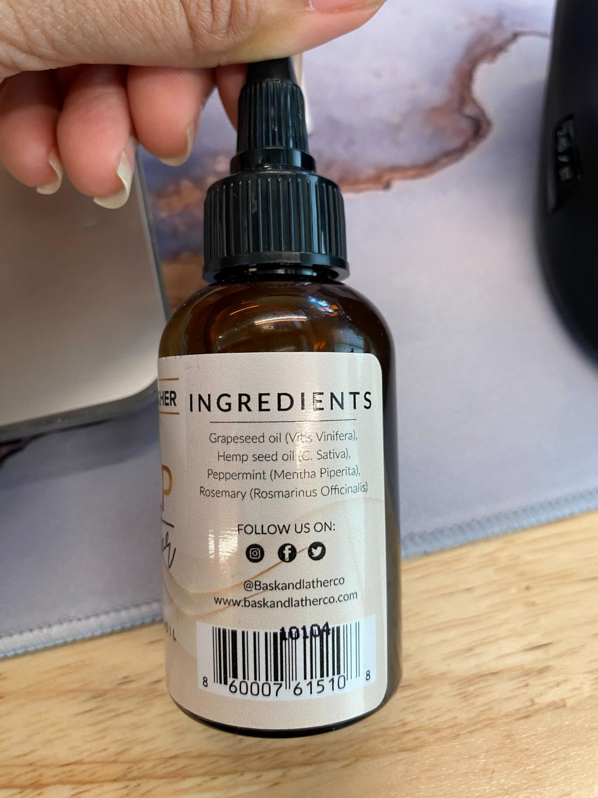 Bask & Lather oil applied on scalp during massage promoting circulation
