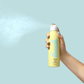 Bask bottle in hand illustrating 5.5 oz travel-friendly size