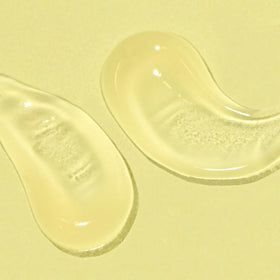 Bask tube beside common objects to show compact travel size
