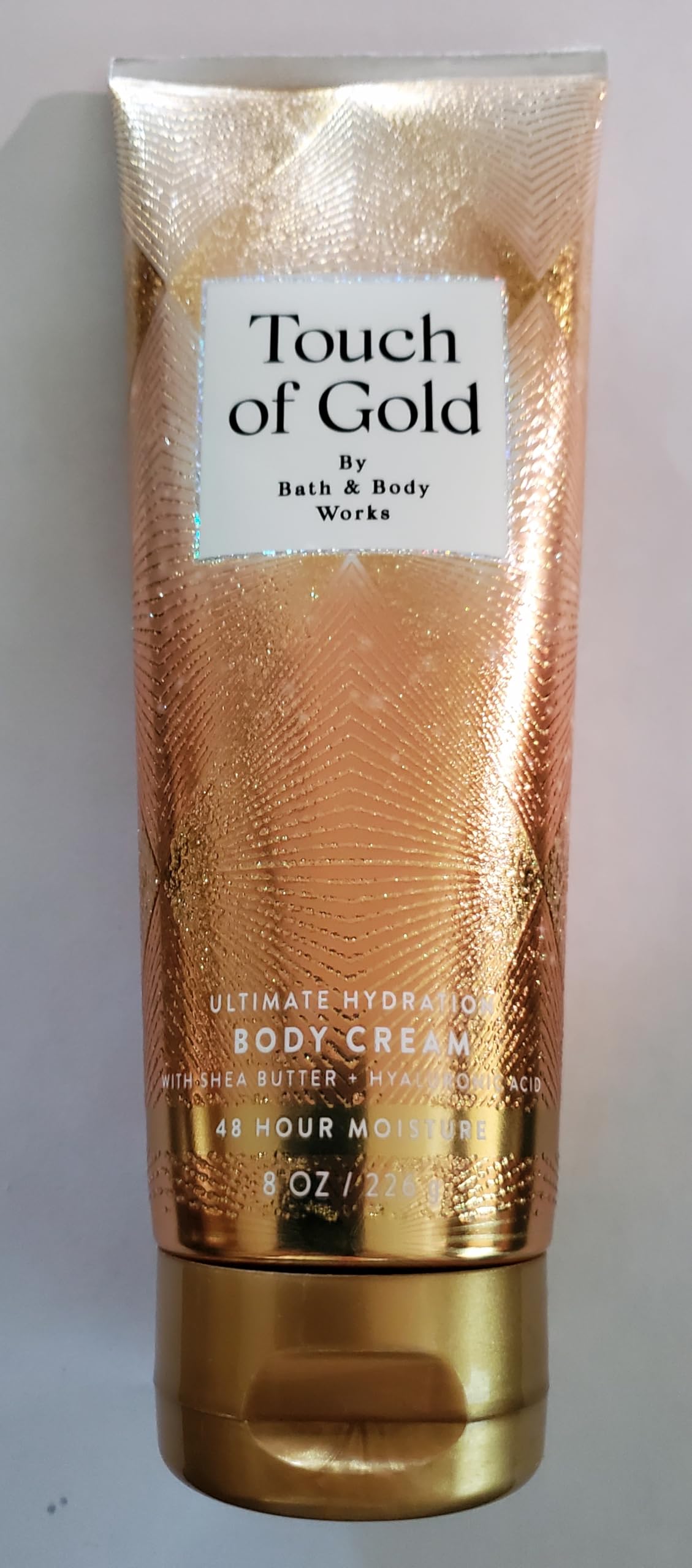 Bath & Body Works cream being applied to arm, fast-absorbing moisture benefit
