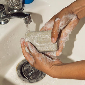 Baxter of California bar producing creamy lather in shower for hydrated skin