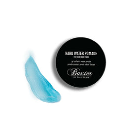 Baxter of California 2 fl oz container next to passport showing travel convenience