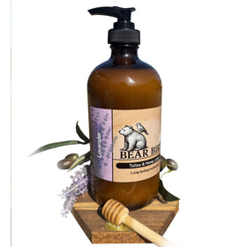 Bear Bird lotion texture on spoon revealing creamy tallow blend for deep nourishment