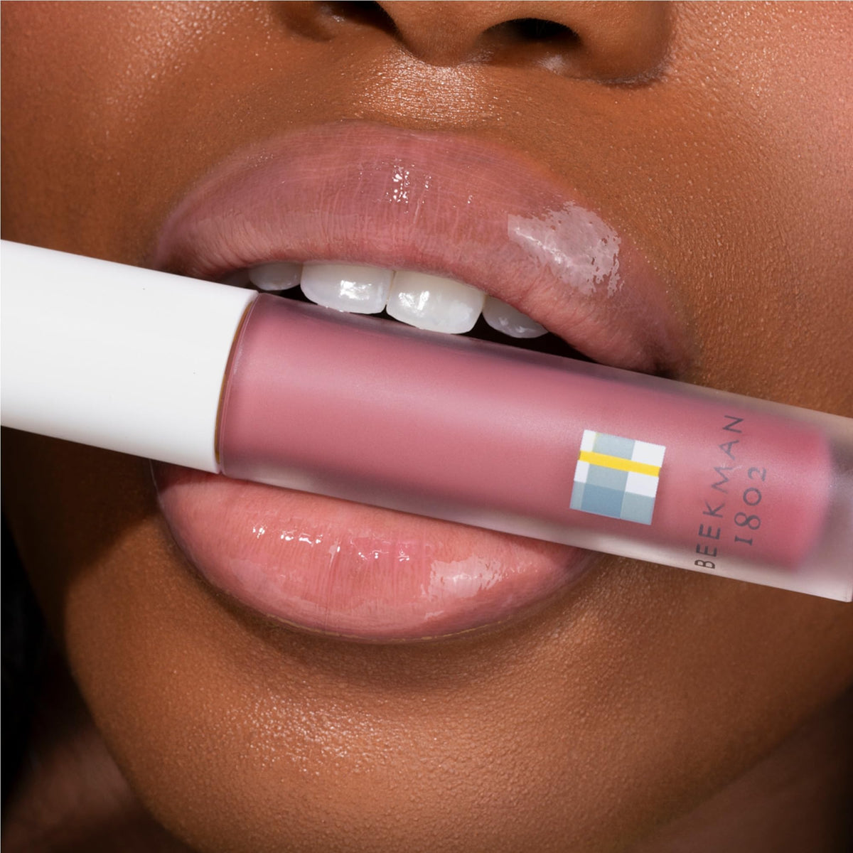 Beekman 1802 lip oil in purse flatlay showing convenient portability