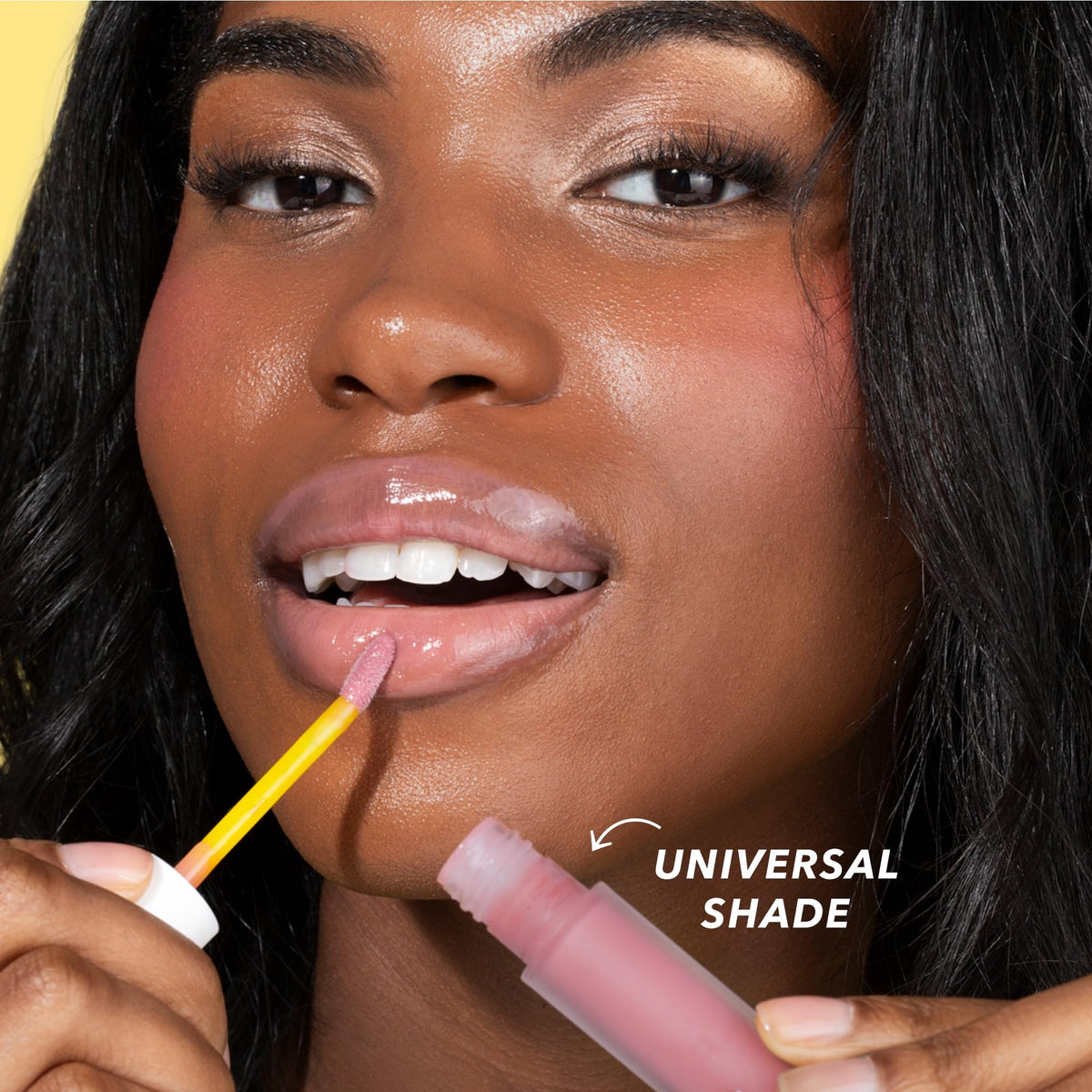 Beekman 1802 model applying lip oil for glossy, conditioned lips