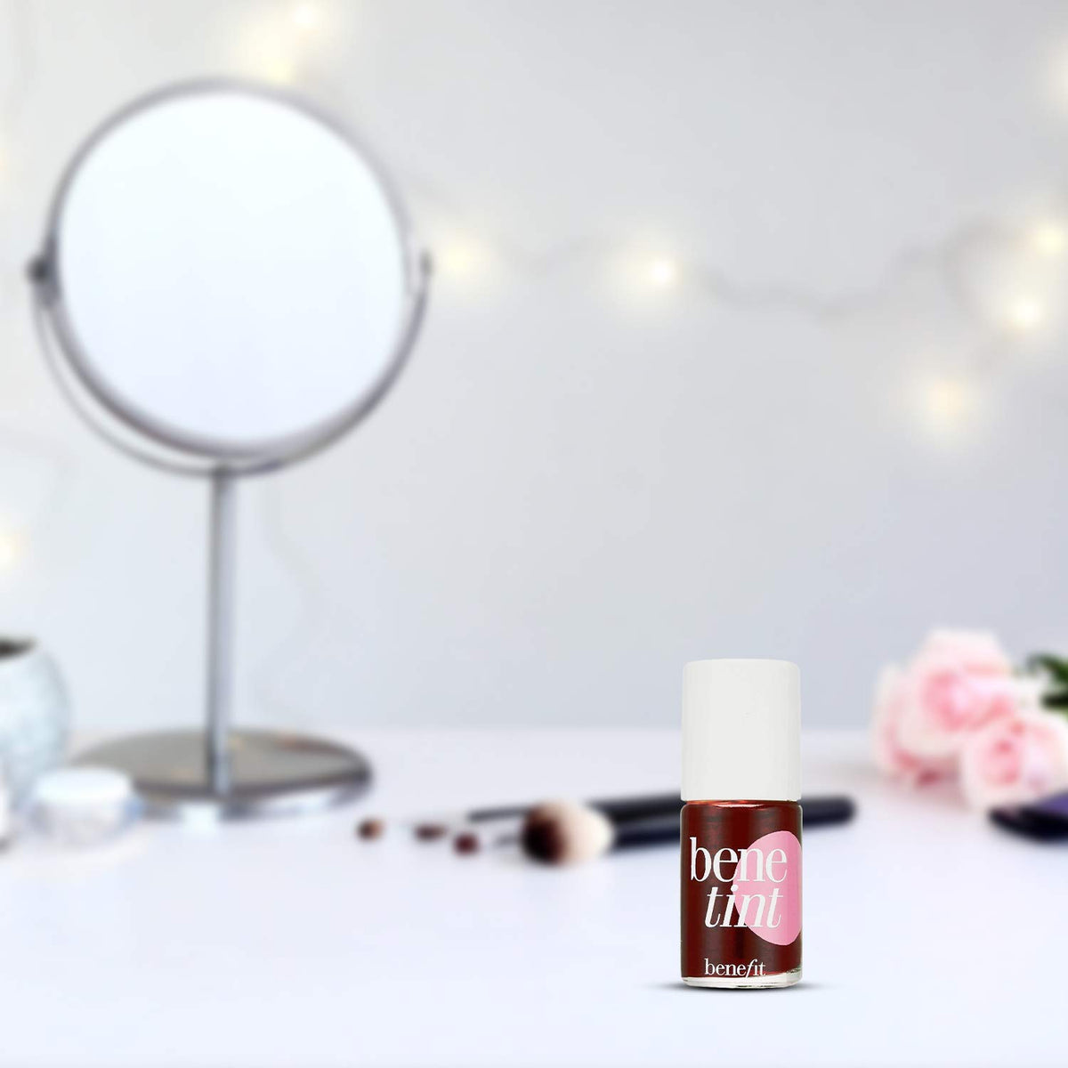 Benefit Benetint travel bottle inside a purse demonstrating easy touch-up convenience on the go