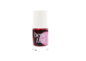 Benefit Benetint next to travel items showing compact 0.33 oz size convenience