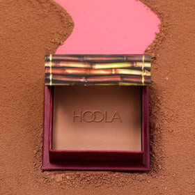 Benefit Hoola in makeup bag lifestyle shot showing easy portability and everyday warming benefit